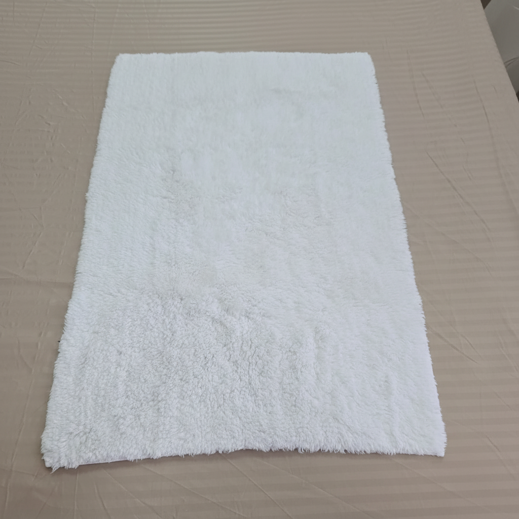 Luxe white shaggy bath mat with no tags, clean product shot