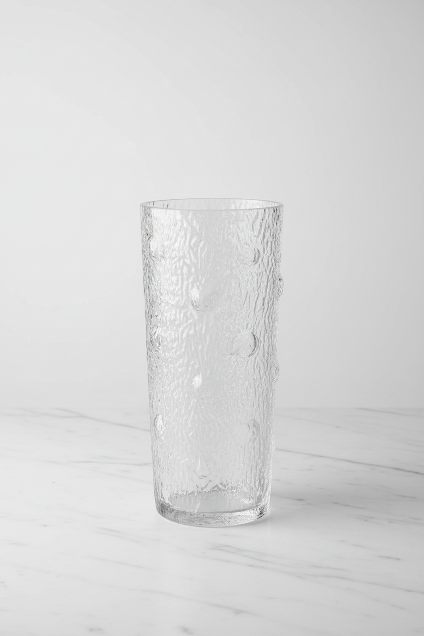 Textured glass bark vase on white marble with studio lighting