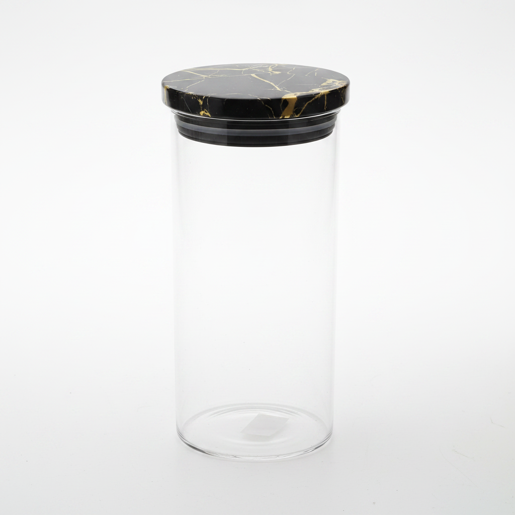 Clear glass storage jar with black and gold marble lid — studio photography