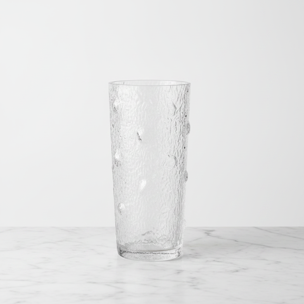 Textured glass bark vase on white marble with studio lighting